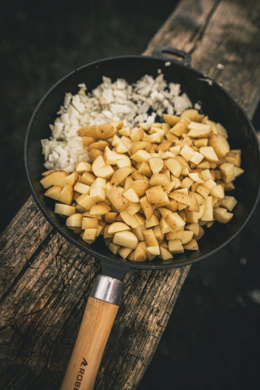 Robens Tahoe Pan lifestyle image of pan on wood with potatoes and onions in the pan 